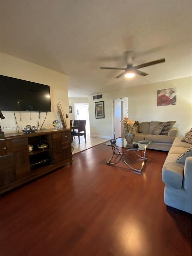 living room featuring ceiling fan and hardwood / wood-style floors