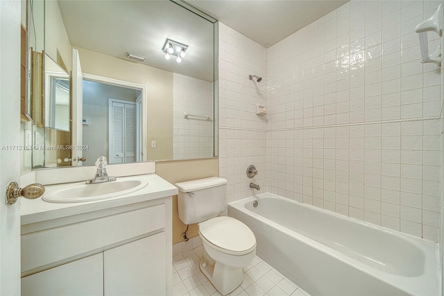 full bathroom featuring tile patterned floors, vanity, toilet, and tiled shower / bath