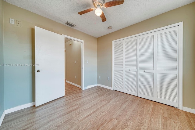 unfurnished bedroom featuring a closet, ceiling fan, light hardwood / wood-style flooring, and a textured ceiling