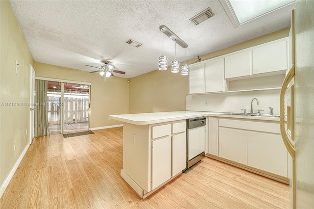 kitchen featuring white cabinetry, white appliances, kitchen peninsula, and sink