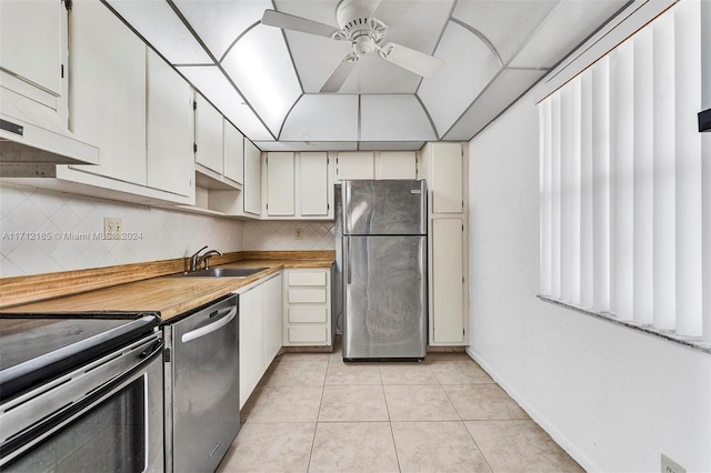 kitchen with backsplash, white cabinetry, sink, and stainless steel appliances