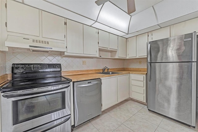 kitchen with ceiling fan, sink, backsplash, light tile patterned floors, and appliances with stainless steel finishes