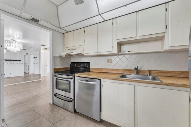 kitchen featuring white cabinetry, sink, stainless steel appliances, light tile patterned floors, and custom exhaust hood