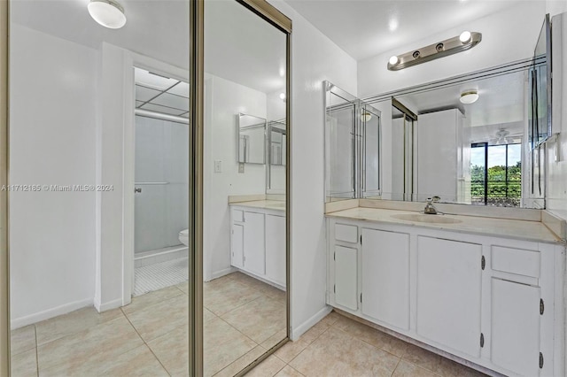 bathroom featuring tile patterned flooring, vanity, and toilet