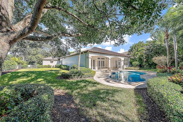 back of property featuring a patio area, ceiling fan, and a yard