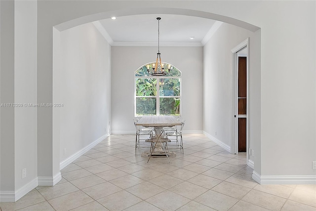 unfurnished dining area featuring light tile patterned floors, a chandelier, and ornamental molding