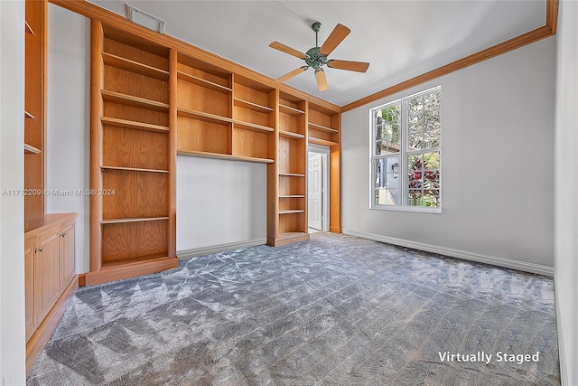 unfurnished bedroom featuring ceiling fan, crown molding, and dark carpet