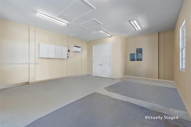 empty room featuring concrete flooring, electric panel, and an AC wall unit