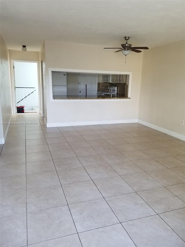 unfurnished living room with ceiling fan and light tile patterned flooring