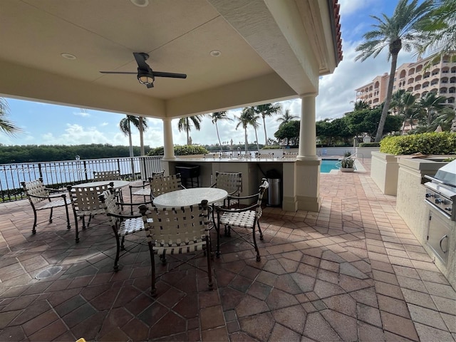 view of patio / terrace with ceiling fan, grilling area, and a community pool