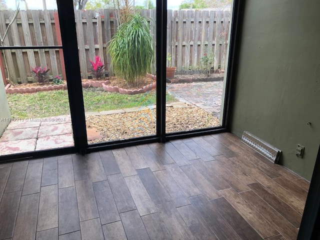 doorway to outside featuring hardwood / wood-style floors and a healthy amount of sunlight