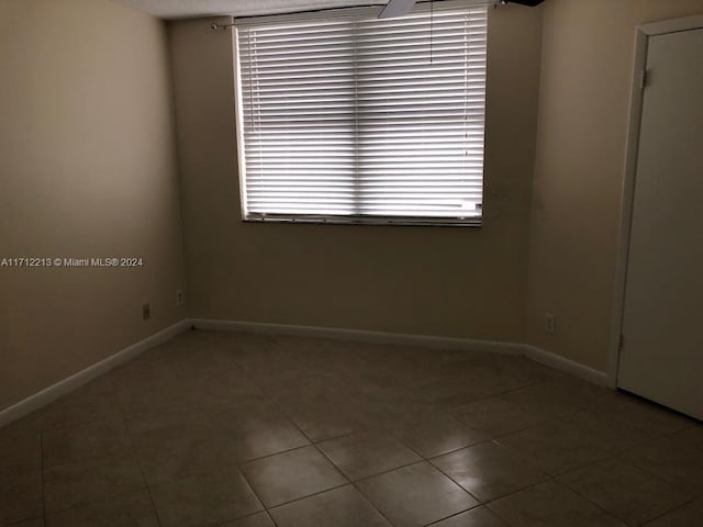 unfurnished room with tile patterned floors and a healthy amount of sunlight