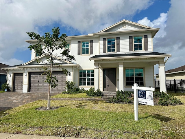 view of front of home with a front yard and a garage