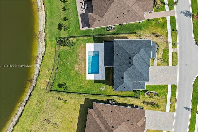 birds eye view of property with a water view