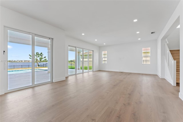 unfurnished living room with light wood-type flooring