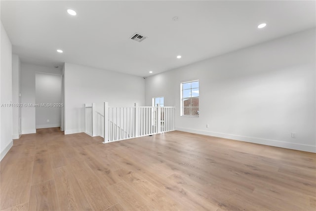 spare room with light hardwood / wood-style flooring