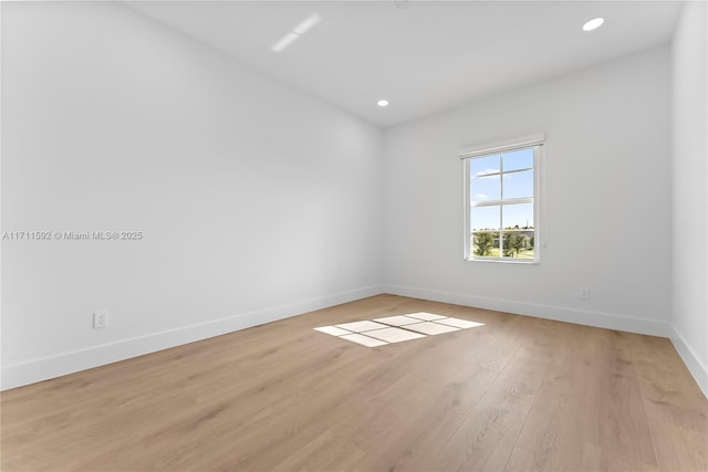 spare room with light hardwood / wood-style floors