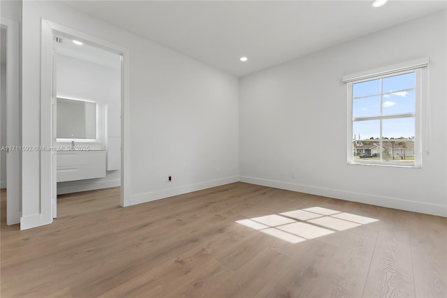 unfurnished room with light wood-type flooring