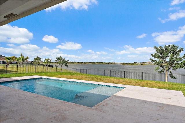 view of pool featuring a patio area, a lawn, and a water view