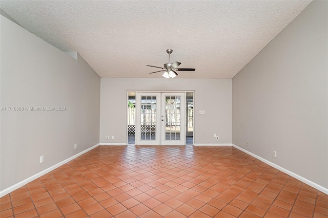 tiled empty room with ceiling fan, french doors, and a textured ceiling