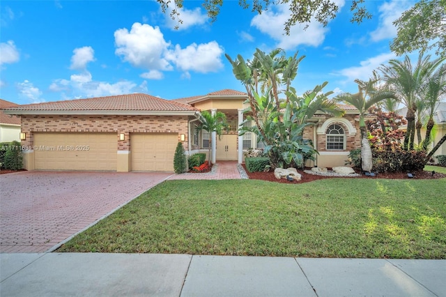 mediterranean / spanish-style home with a front lawn and a garage