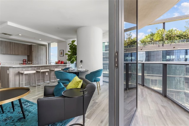 interior space featuring expansive windows and light hardwood / wood-style flooring