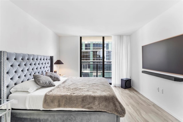 bedroom featuring access to outside and light hardwood / wood-style flooring