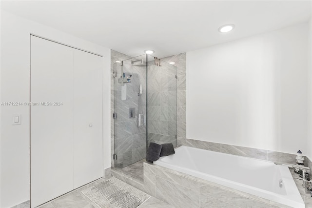 bathroom featuring separate shower and tub