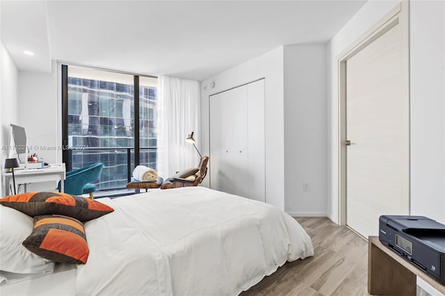 bedroom with a closet and light hardwood / wood-style flooring