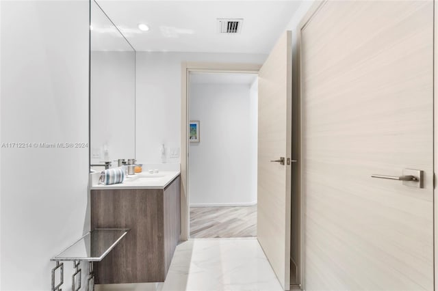 bathroom featuring vanity and hardwood / wood-style flooring