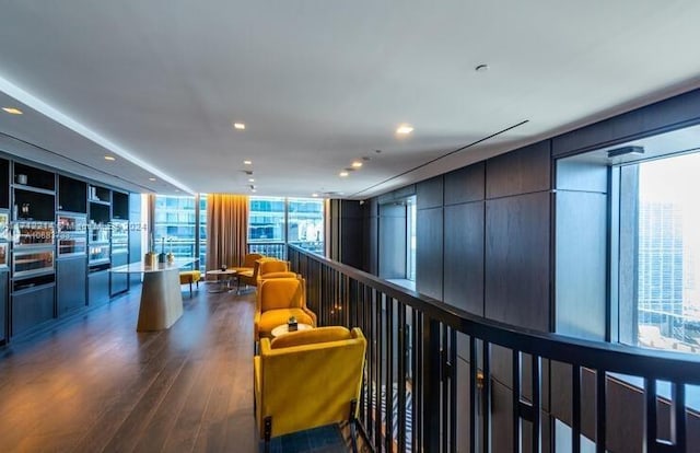 hallway featuring floor to ceiling windows and dark hardwood / wood-style flooring