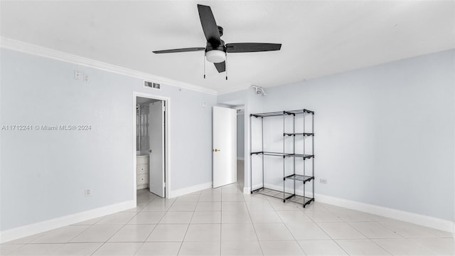 interior space with ceiling fan, light tile patterned floors, and crown molding