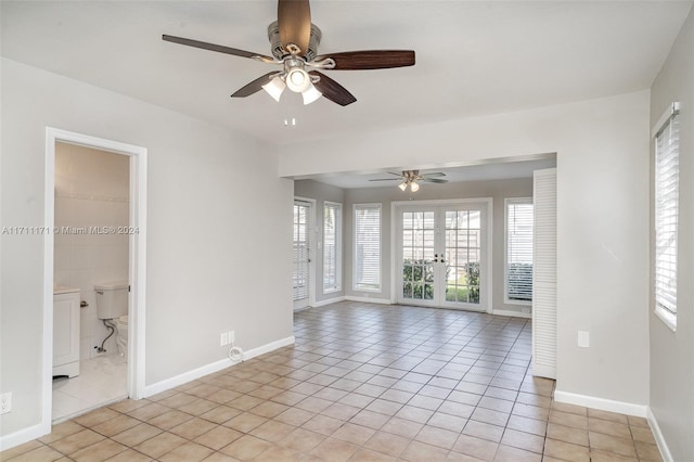 spare room with french doors and light tile patterned flooring