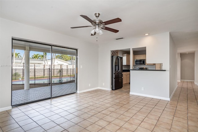 interior space with light tile patterned flooring and ceiling fan