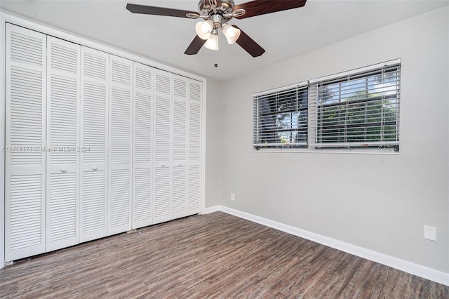 unfurnished bedroom with hardwood / wood-style flooring, a closet, and ceiling fan