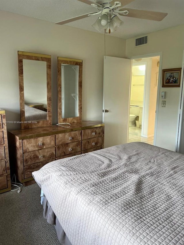 bedroom with carpet, ceiling fan, and a textured ceiling