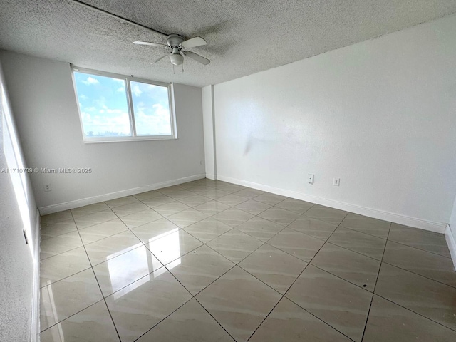 unfurnished room with tile patterned flooring, ceiling fan, and a textured ceiling