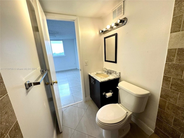 bathroom with vanity, tile patterned floors, and toilet