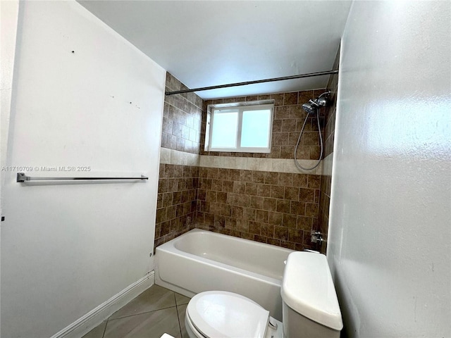 bathroom featuring tile patterned flooring, toilet, and tiled shower / bath