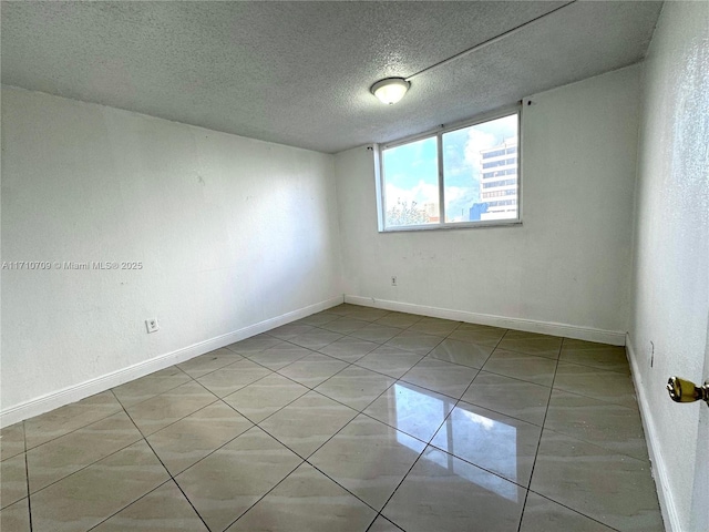 spare room with a textured ceiling