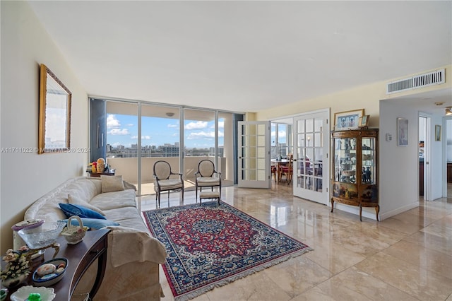 living room featuring french doors and expansive windows