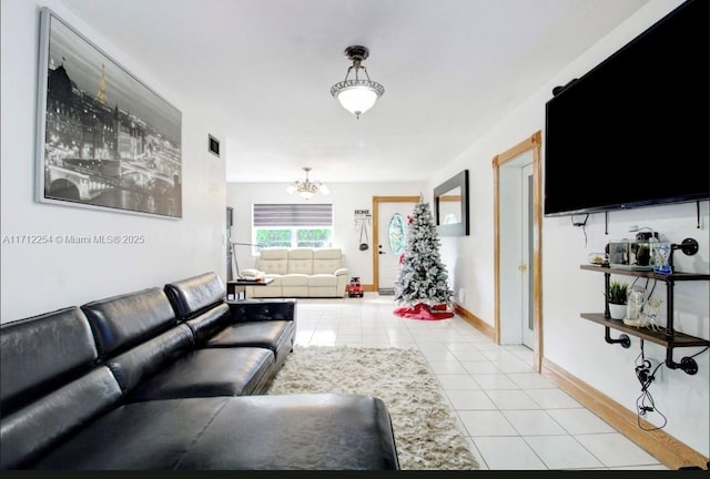 tiled living room featuring an inviting chandelier