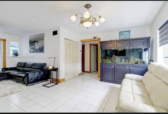 tiled living room featuring a chandelier