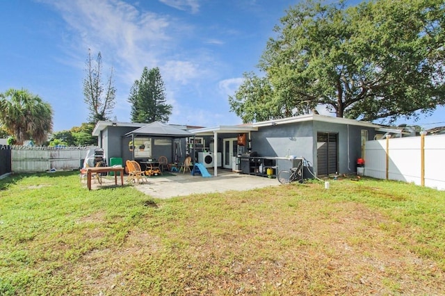 back of property featuring a gazebo, a lawn, and a patio