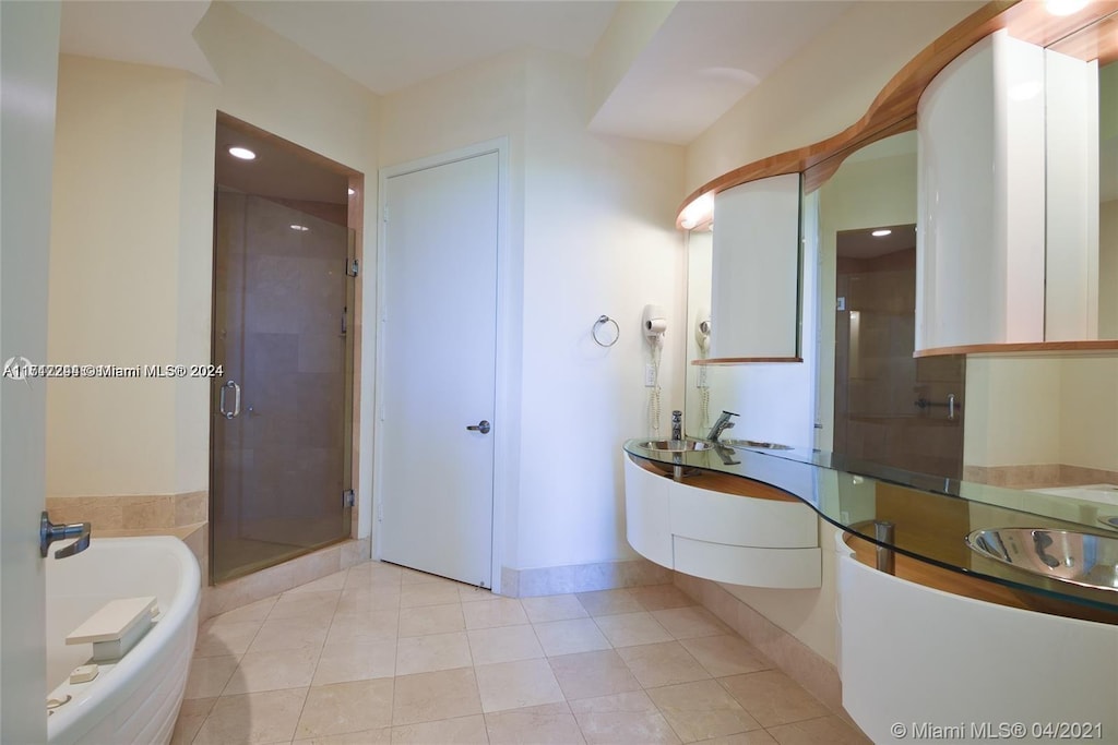 bathroom featuring tile patterned floors, vanity, and an enclosed shower