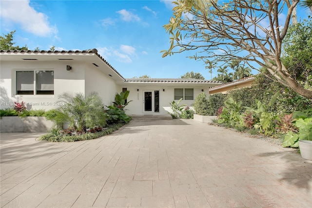 9008 Dickens Ave, Surfside, FL 33154 - mediterranean / spanish house with stucco siding and a tile roof