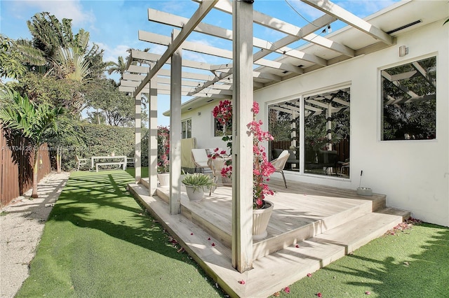 wooden deck featuring a pergola and a yard