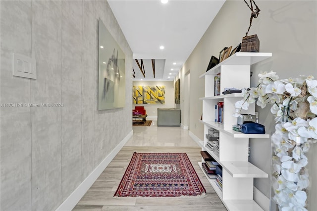 hallway with light hardwood / wood-style flooring