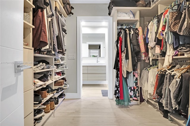 spacious closet with light hardwood / wood-style flooring