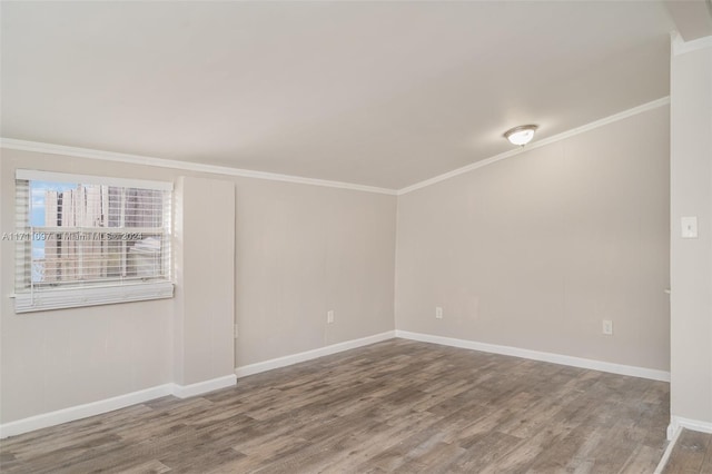 spare room featuring hardwood / wood-style floors and ornamental molding